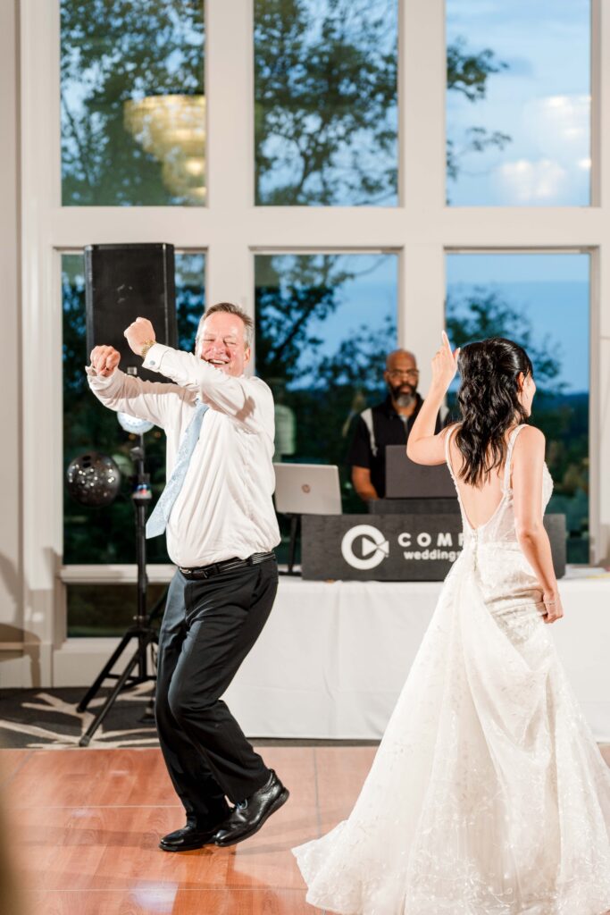 Father of groom and bride share exciting dance