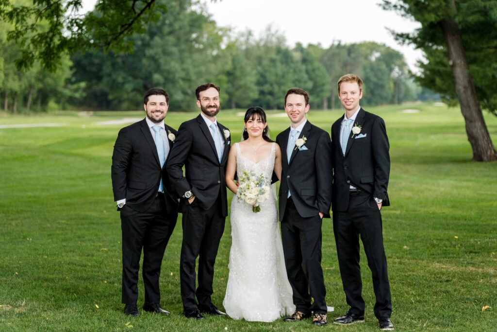 Groomsmen with the couple at the golf course at Blythefield