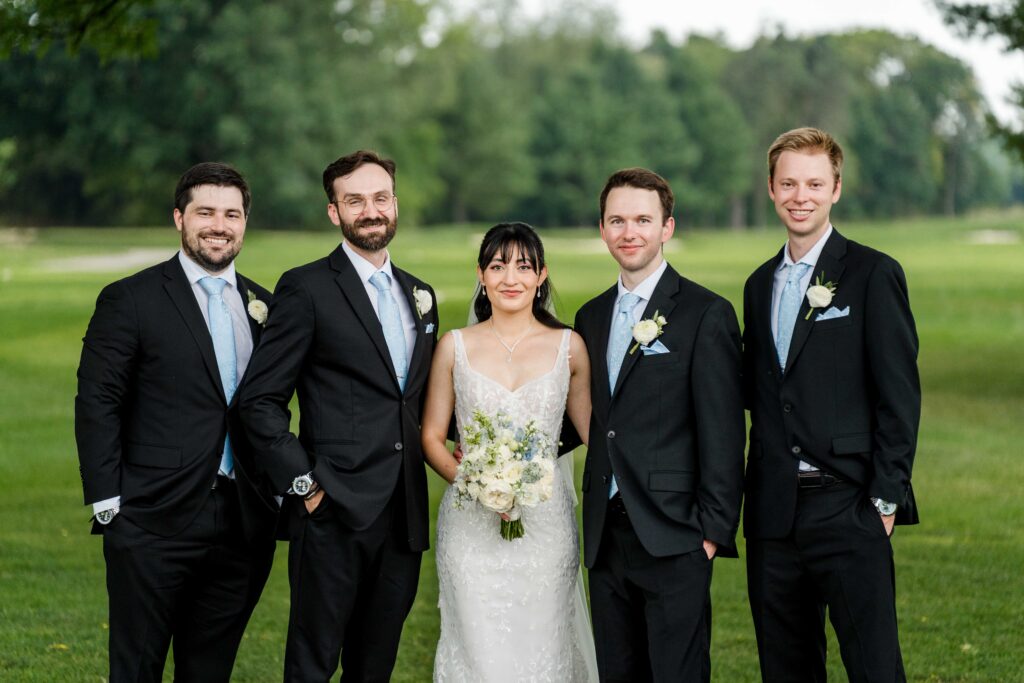 Groomsmen with the couple at the golf course at Blythefield