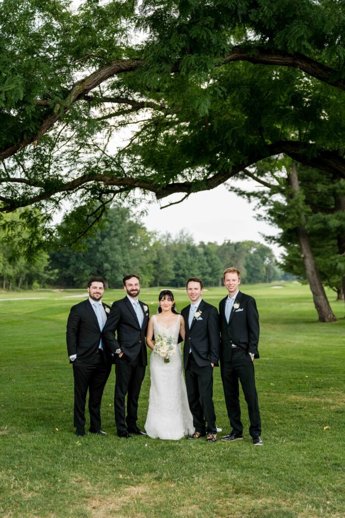 Groomsmen with the couple at the golf course at Blythefield