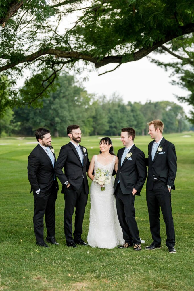 Groomsmen laughing with Max and Sertap on the golf course