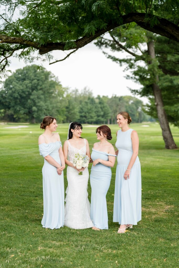 Sertap and her bridesmaids laughing during portraits at Blythefield