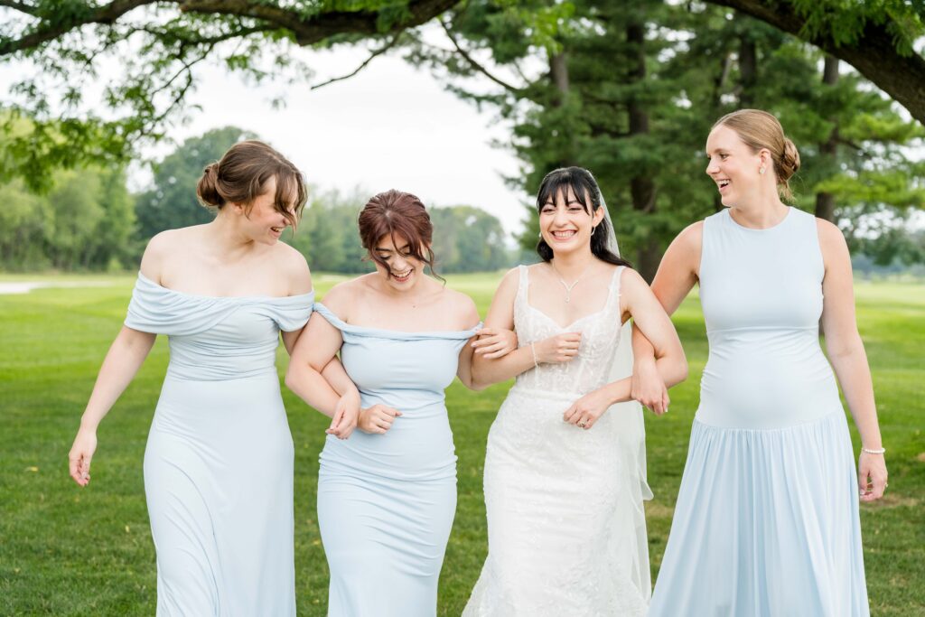 Bride and bridesmaids laughing