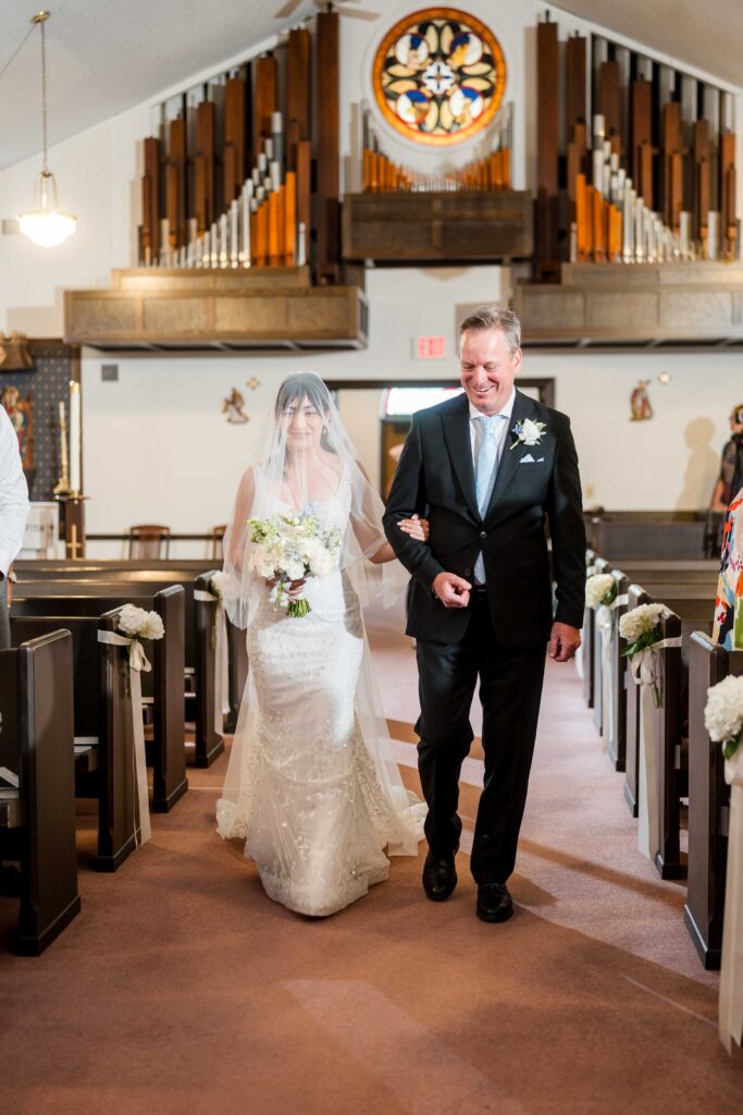 Sertap walks down the aisle at Grand Rapids Church with her father-in-law
