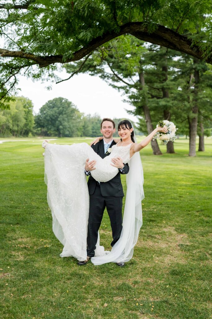 Groom lifting up bride for portraits
