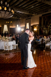 Bride and groom sharing their first dance in the elegant ballroom of the Detroit Athletic Club, captured by Detroit luxury wedding photographers FM Visuals.